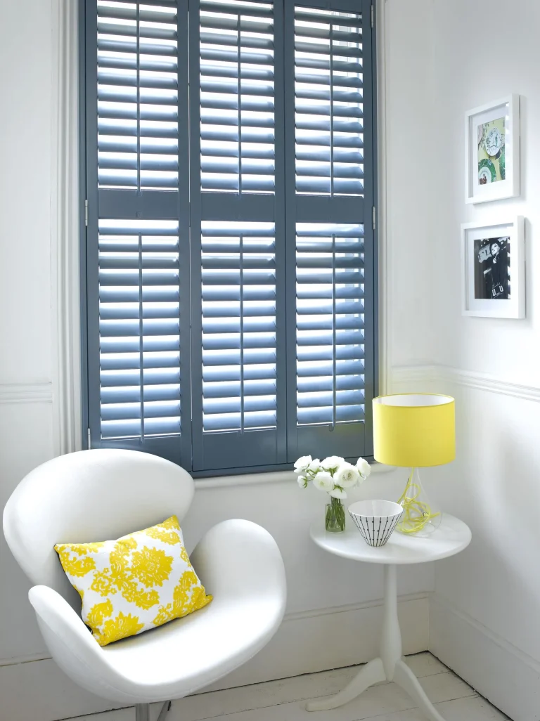 Blue full height shutters in a bright living room